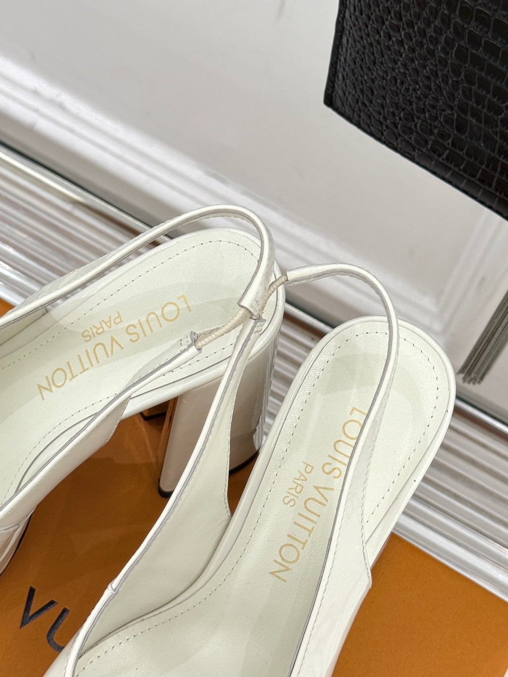 White patent leather mule-style high-heel shoes with LV monogram on insole