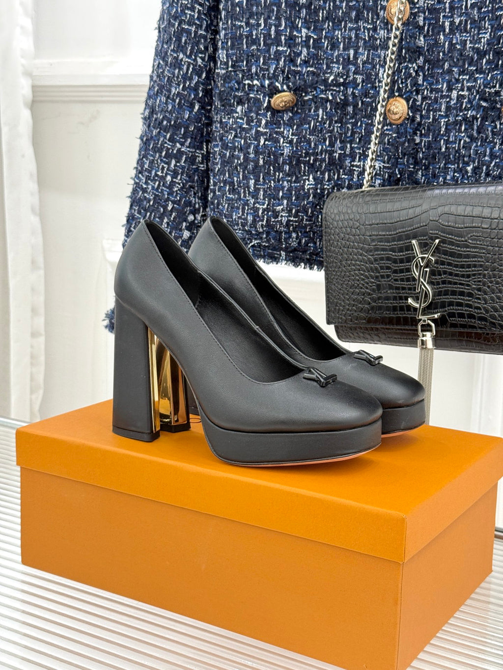 Black leather platform heels with LV monogram at toe and gold-tone heel detail