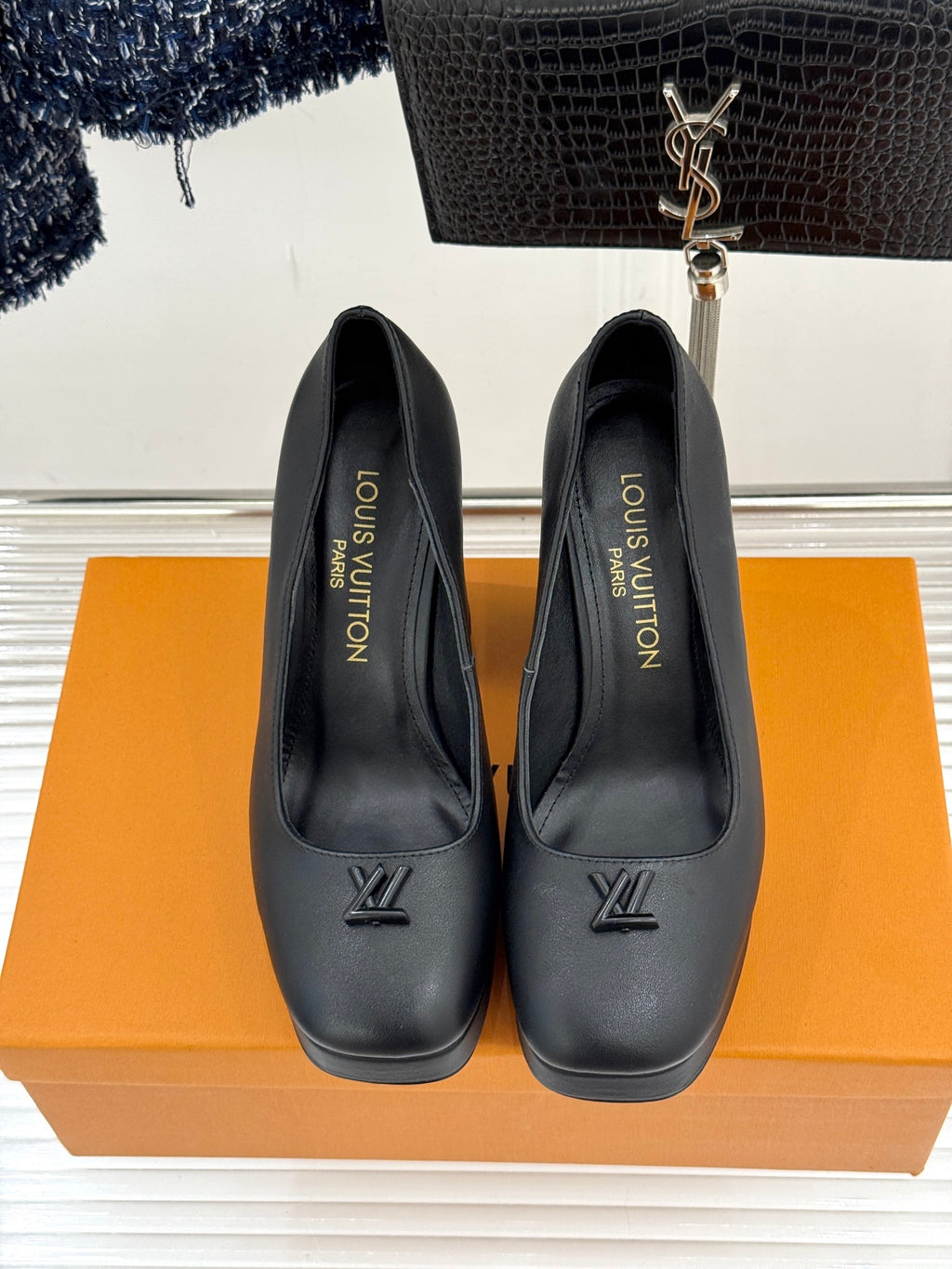 Black leather closed-toe pumps with LV monogram on front and pointed toe silhouette