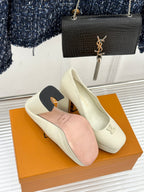 Louis Vuitton cream leather high-heel pumps with LV logo on the toe, block heel