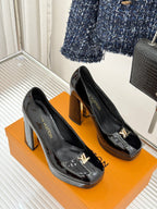 Louis Vuitton black patent high-heel pumps with gold LV emblems, side view