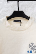 Cream knit sweater neckline with blue-gray floral embroidery on chest