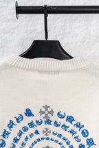 Cream knit long sweater with ribbed collar and blue patterned embroidery