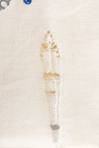 Close-up of cream threaded vertical embroidery on a knit sweater
