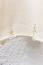 Cream knit long sweater with ribbed hem and small lace ruffle at cuffs