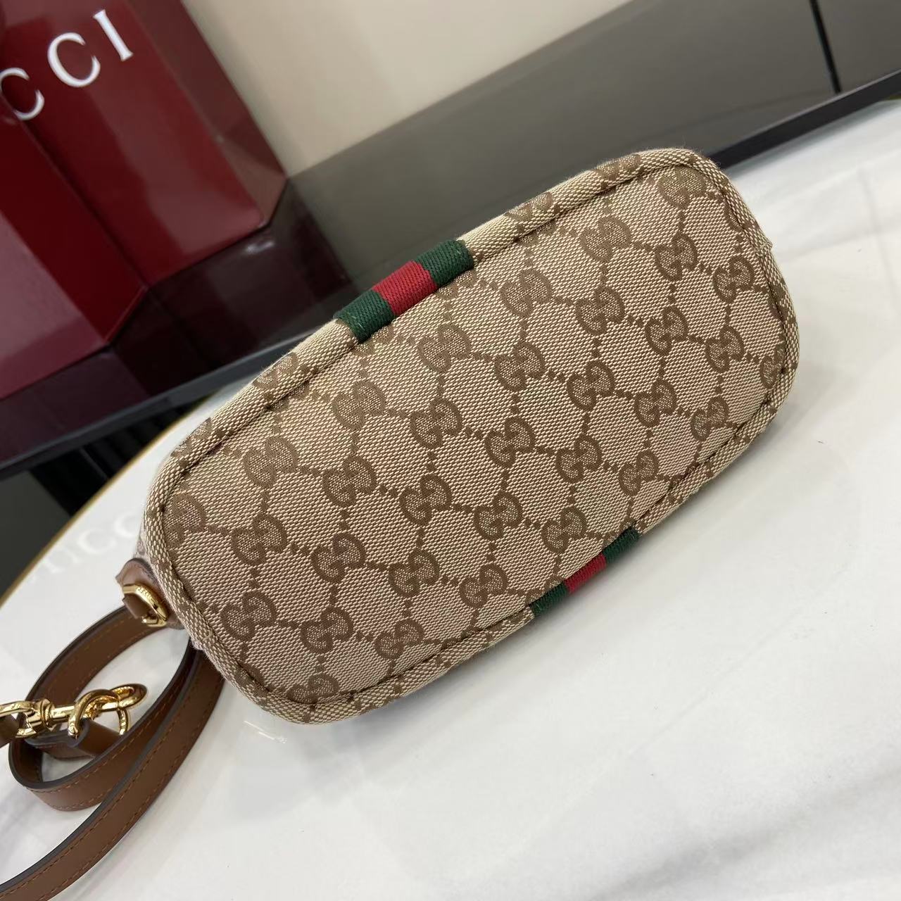 Gucci monogram clutch-style bag in beige with web stripe and gold zipper pull