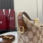 Gucci monogram shoulder bag side view with brown leather strap and gold hardware