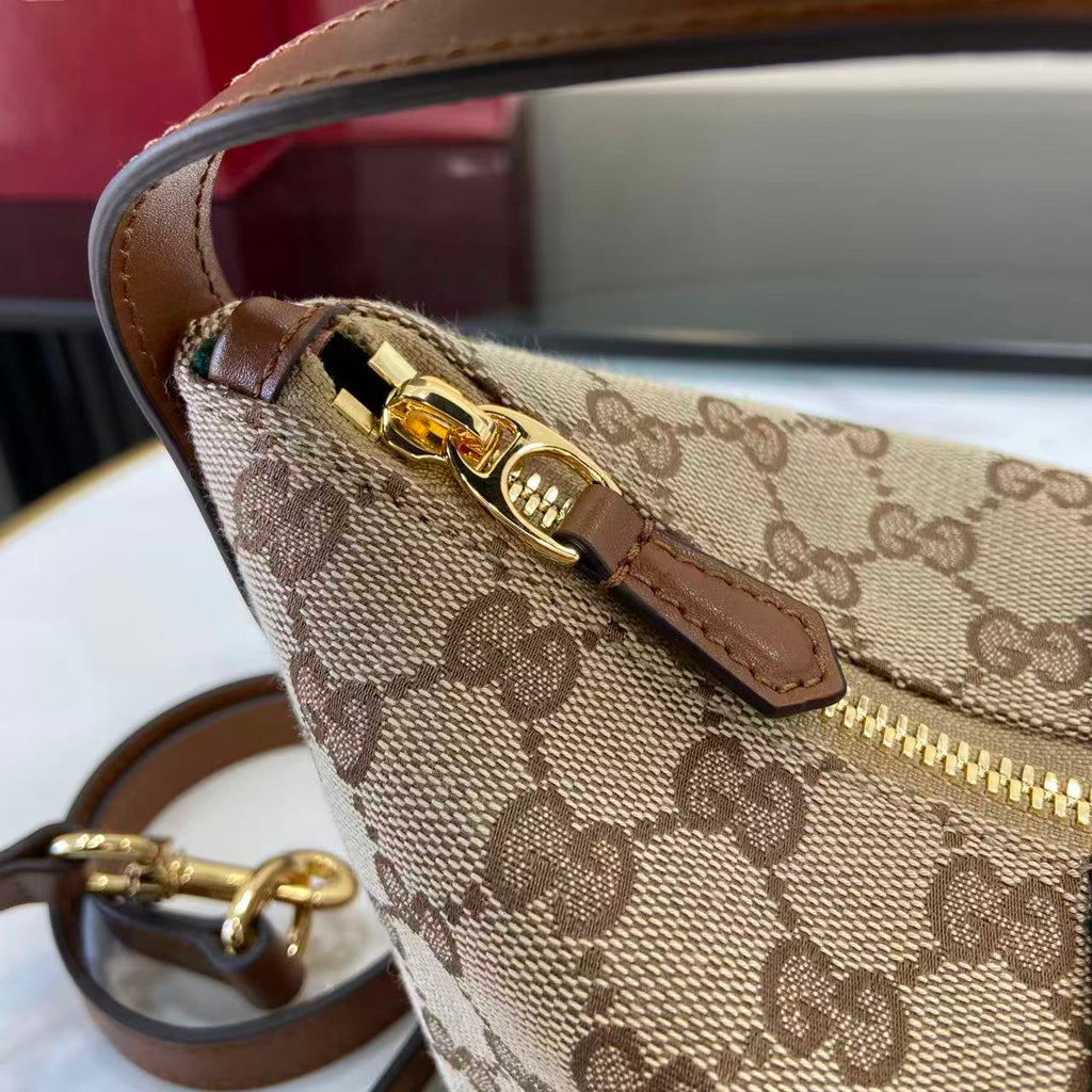 Gucci GG monogram crossbody bag with gold hardware and brown leather strap