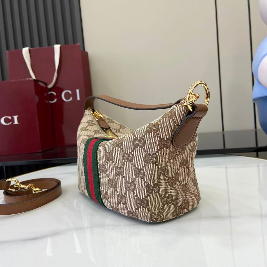 Gucci monogram hobo bag with beige canvas, web stripe, and top gold ring handle