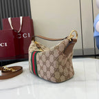 Gucci monogram hobo bag with beige canvas, web stripe, and top gold ring handle