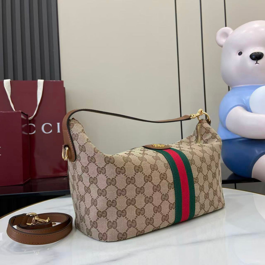 Gucci hobo bag on side view with GG canvas, green/red web stripe and shoulder strap