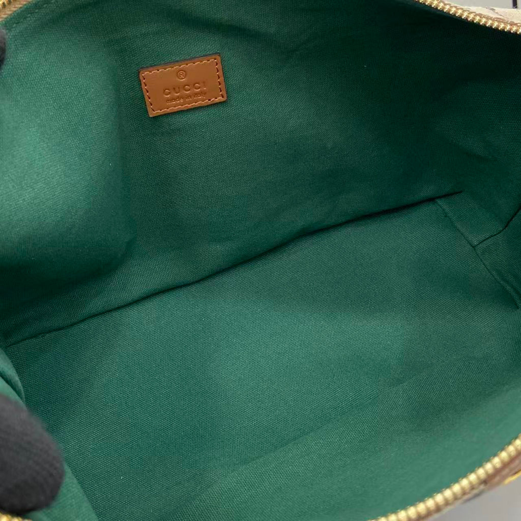 Gucci bag interior lining in green fabric with small leather brand label