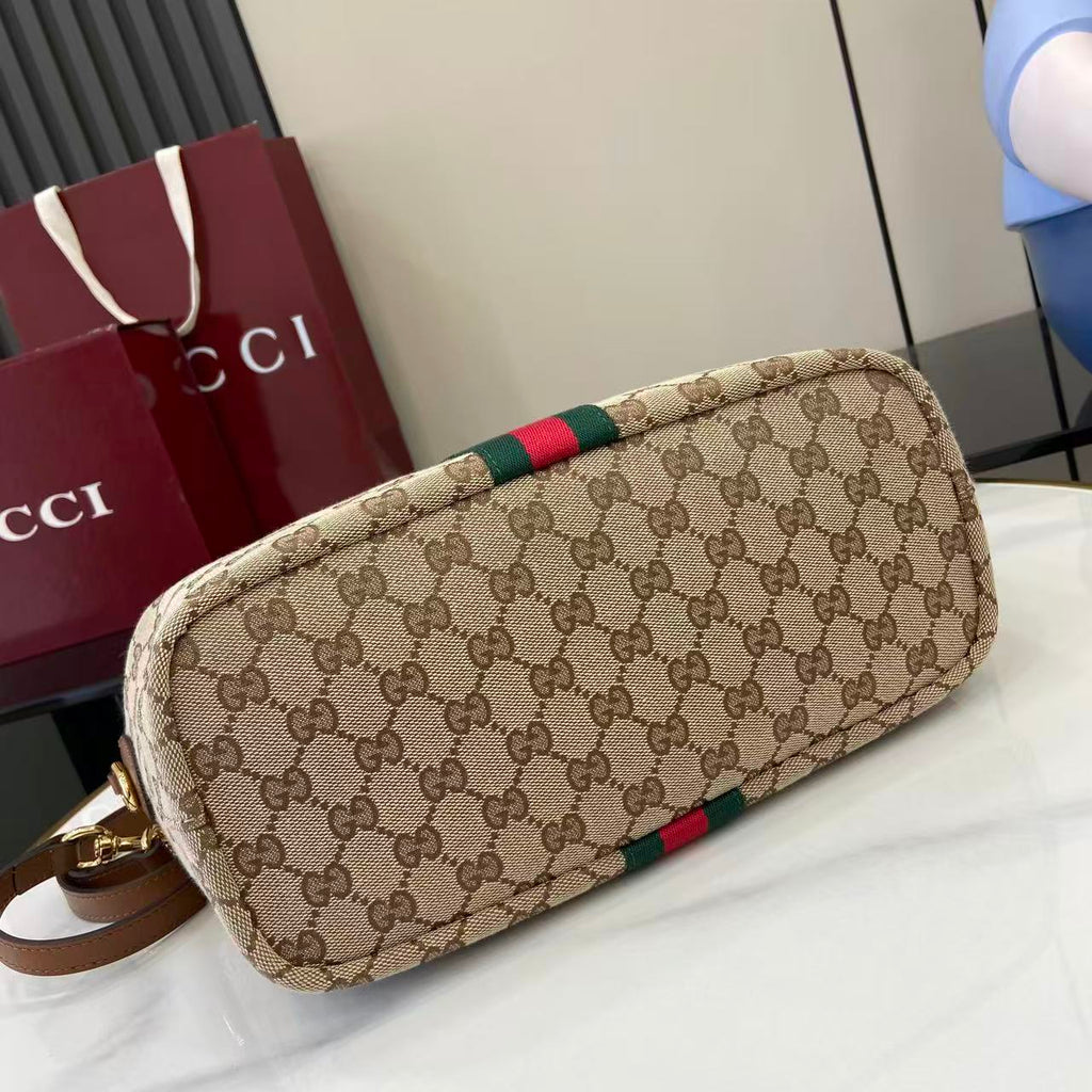 Gucci hobo bag angled view with GG canvas and green/red web stripe, gold hardware