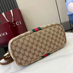 Gucci hobo bag angled view with GG canvas and green/red web stripe, gold hardware