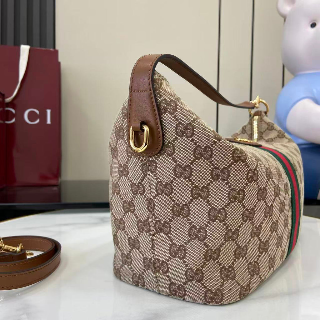 Gucci hobo bag side view with GG canvas, green/red web stripe and top handle