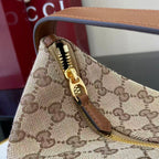Gucci bag close-up of zipper with gold pull on GG canvas and leather trim