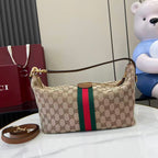 Gucci hobo bag front view with GG canvas, green and red web stripe, gold clasp