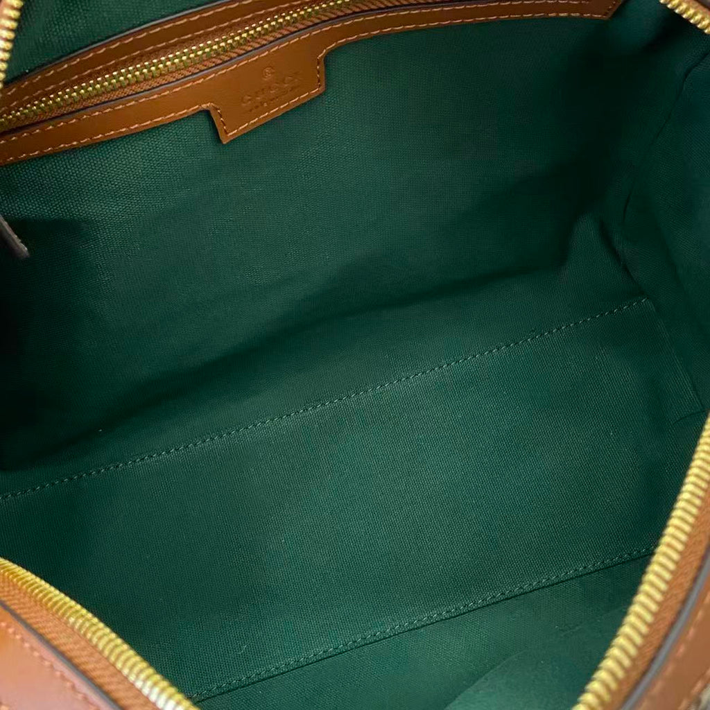 Gucci duffel bag interior lining in green fabric with visible stitched seams
