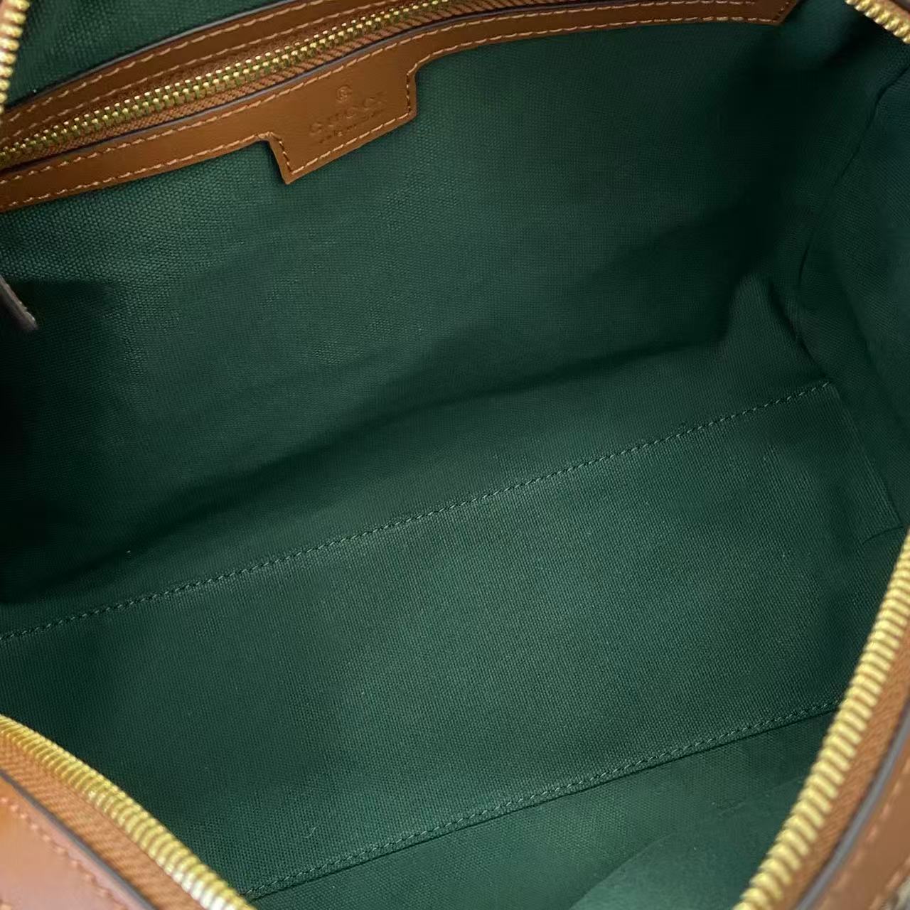 Gucci duffel bag interior lining in green fabric with visible stitched seams