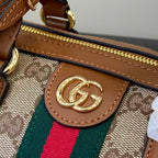 Gucci bag close-up: GG canvas with Gucci logo medallion, brown leather edge trim, zipper track