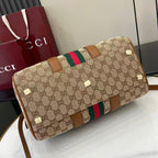 Gucci duffel bag end view with GG canvas, green and red web stripe, brown leather details