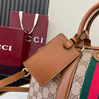 Gucci bag close-up of front pocket with brown leather flap, GG canvas, and web stripe