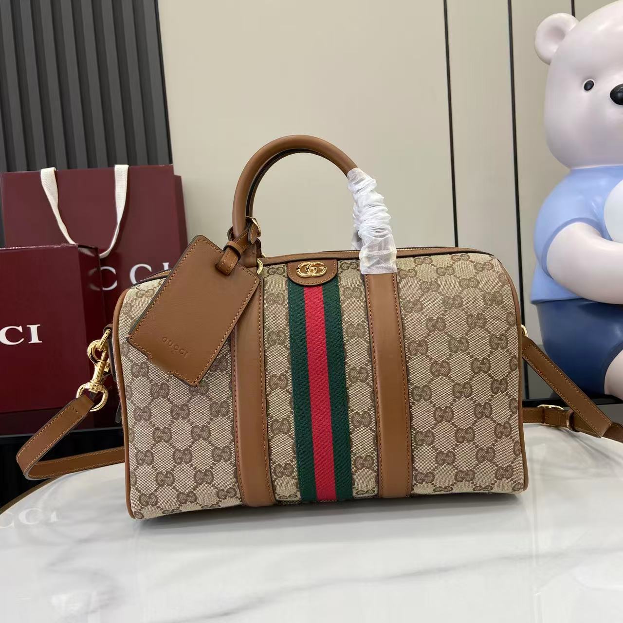 Gucci duffel bag with GG canvas, multicolor web stripe, brown leather trim, top handles