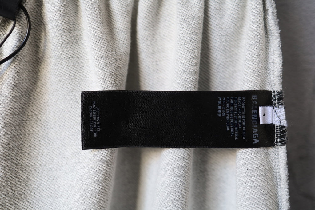 Balenciaga pants with black label tag on light gray waistband