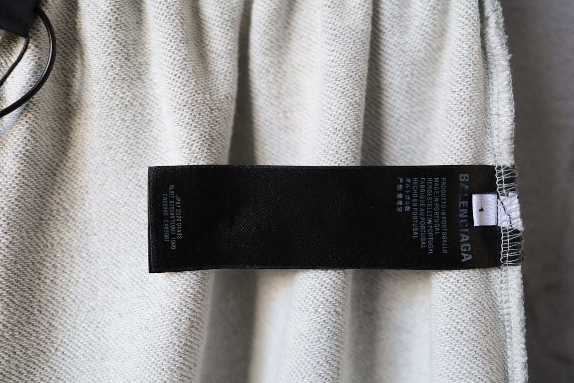 Balenciaga pants with black label tag on light gray waistband