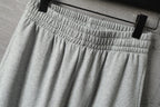 Light gray Balenciaga pants with elastic waistband and gathered pleats