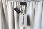 Light gray pants with hang tag reading Balenciaga