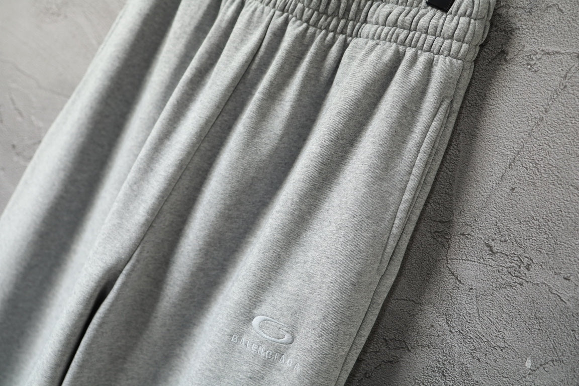 Light gray wide-leg pants with small logo detail on fabric