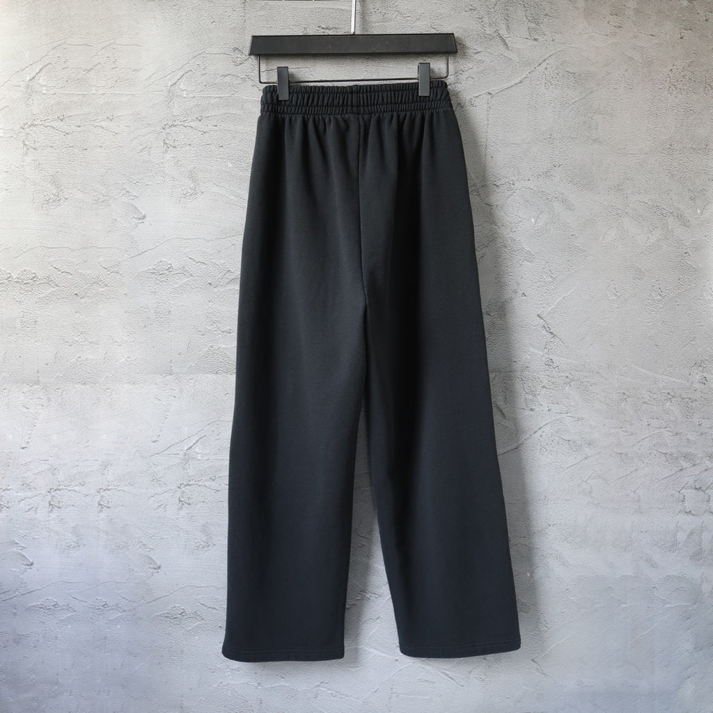 Black wide-leg pants with elastic waistband and front pleat seam detail