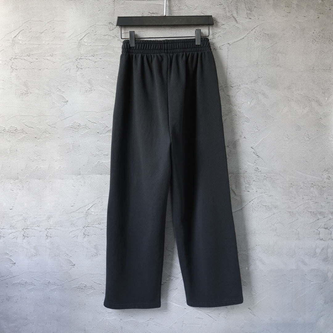 Black wide-leg pants with elastic waistband and front pleat seam detail