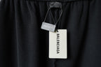 Black pants with hanging Balenciaga tags attached at waistband