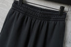 Black elastic-waist pants with ruched waistband and belt loops