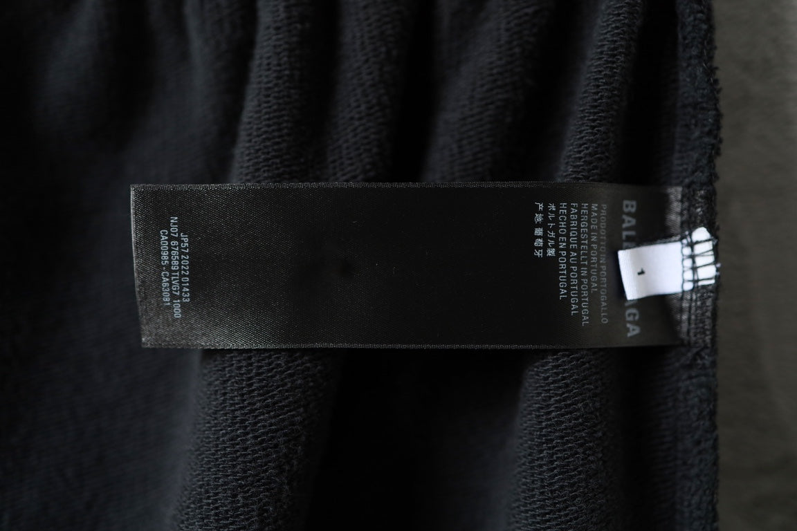 Dark pants with interior care label and brand label tag near the waistband