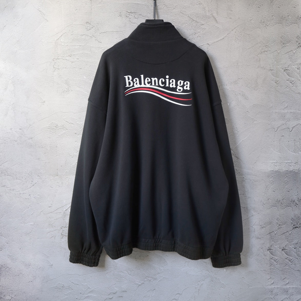 Balenciaga black zip-up hoodie with large Balenciaga logo graphic on the back