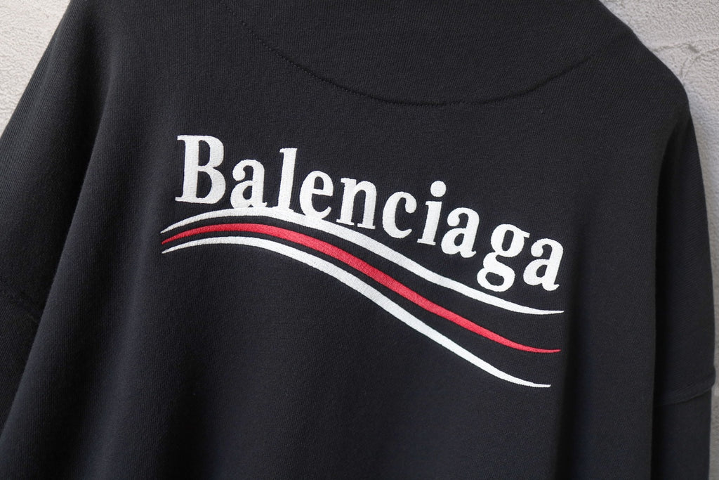 Balenciaga hoodie back logo close-up with red-and-white curved stripe lettering