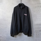 Zip-up jacket with stand collar, front zipper, and side pockets, dark color.