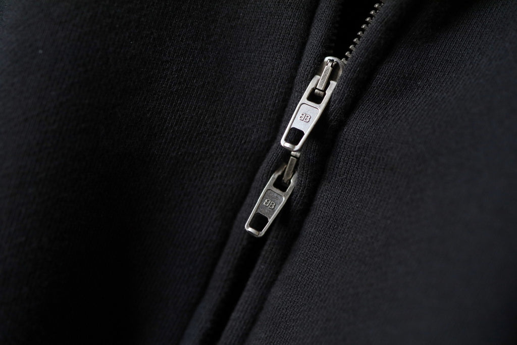 Balenciaga zip-up hoodie close-up of metal zipper pull and slider