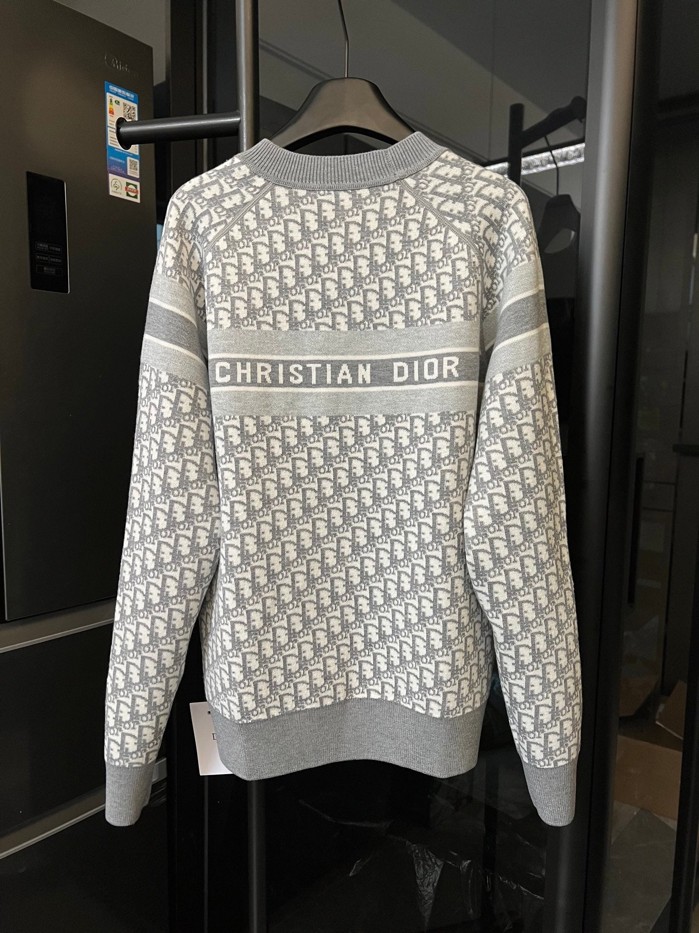 Light gray Dior monogram knit sweater with centered “CHRISTIAN DIOR” band