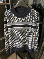 Long-sleeve knit sweater with white logo monogram print, navy cuffs and hem stripe