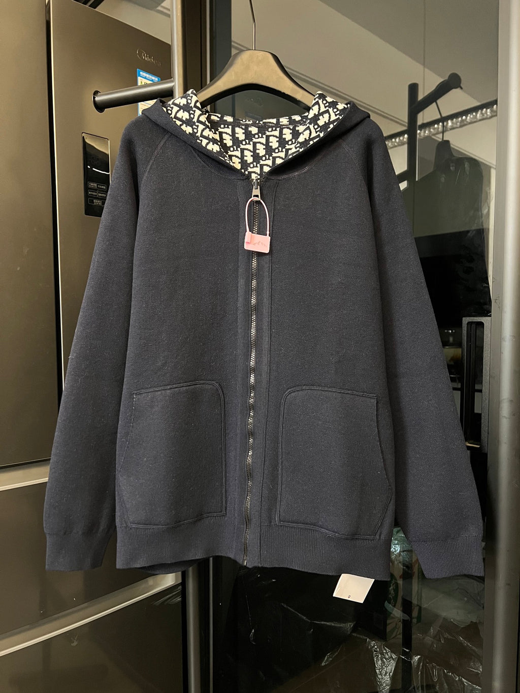 Dior long zip hoodie in dark gray with hood, front pockets, and center zipper