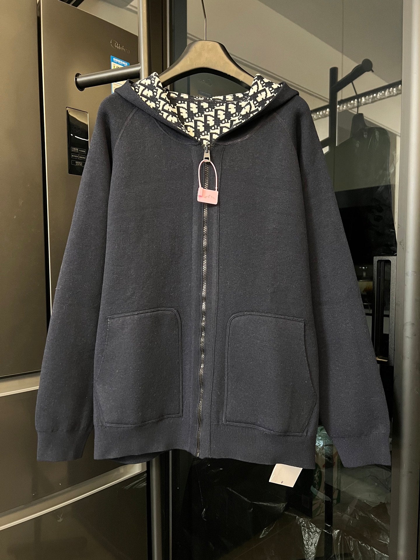 Dior long zip hoodie in dark gray with hood, front pockets, and center zipper