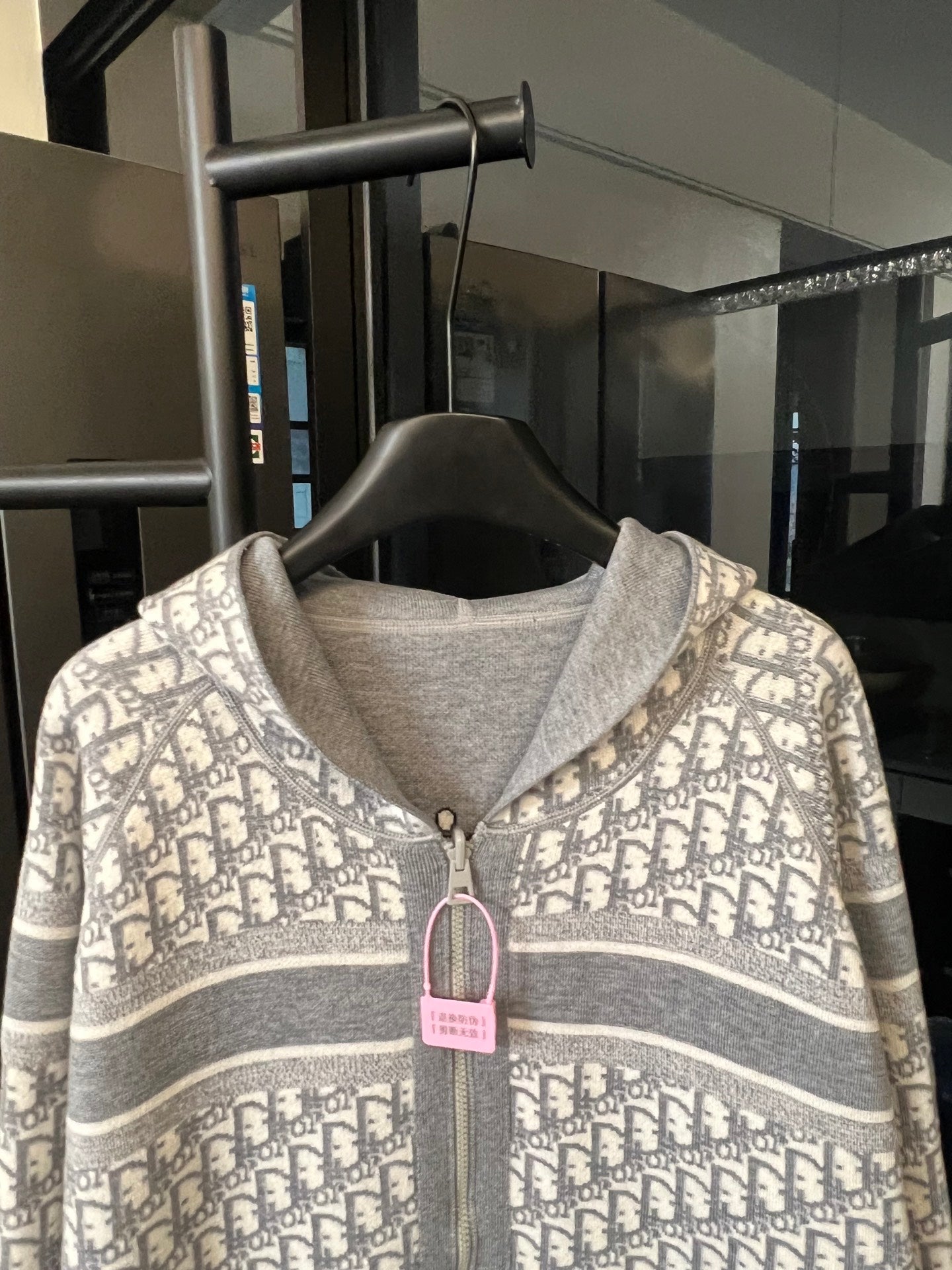 Zip-up hoodie close-up with Dior monogram hood and front zipper