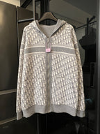Zip-up hoodie with full Dior monogram pattern, hood, and front zipper