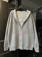 Zip-up hoodie with hood and light gray body, featuring Dior monogram hood lining