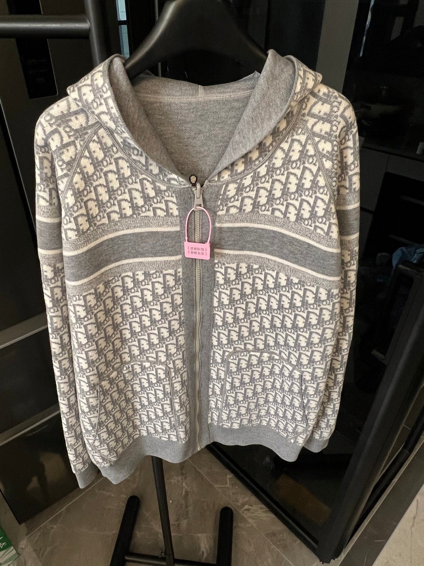 Zip-up hoodie with Dior monogram pattern, hood, and front zipper detail