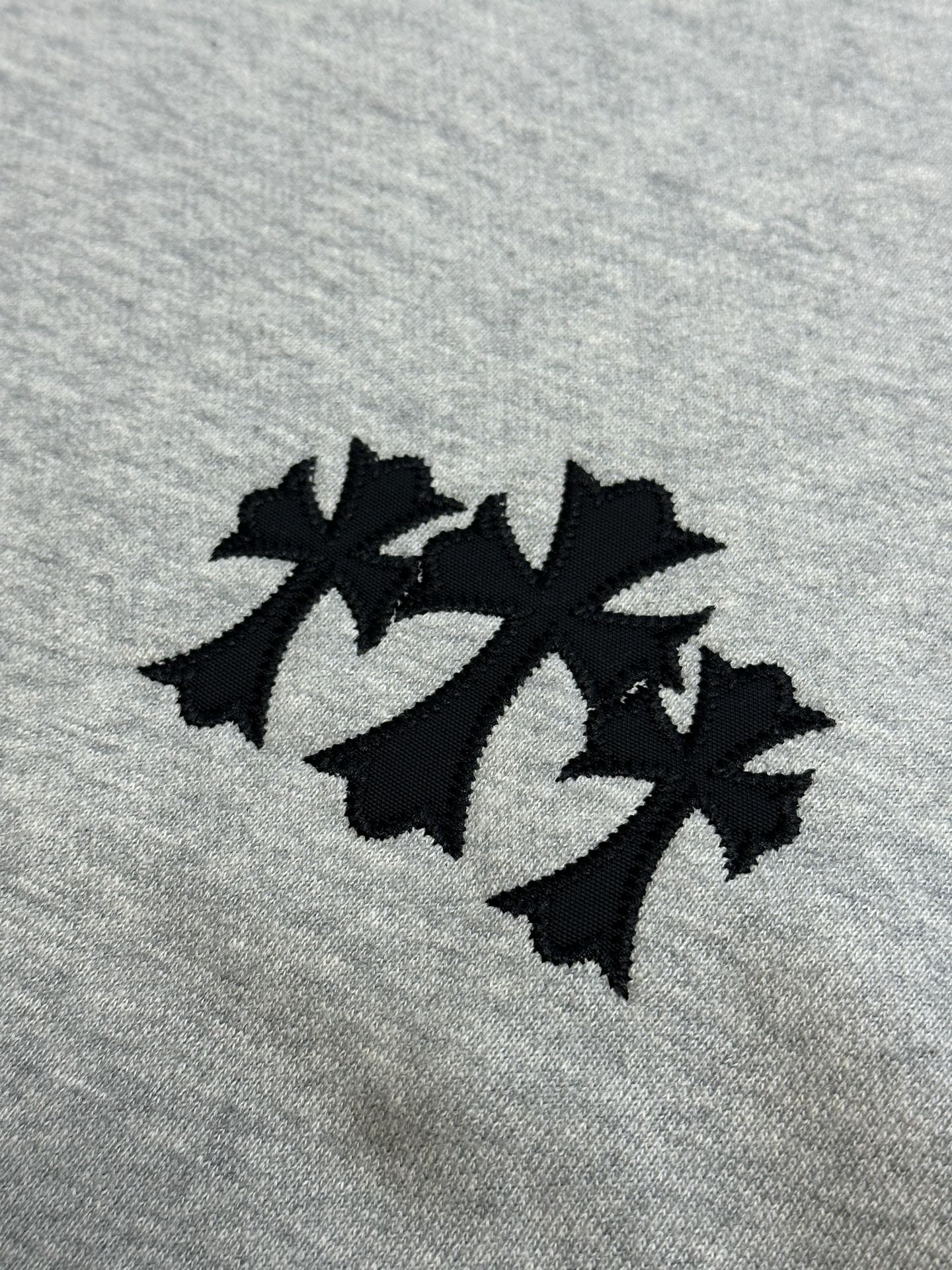 Light gray sweatshirt fabric with three-leaf black logo patch